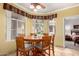 Bright dining area with a round wood table, seating for six, and natural light from the window at 3830 E Lakewood Pkwy # 1057, Phoenix, AZ 85048