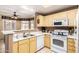 Efficient kitchen with white countertops, neutral cabinets, and updated appliances for convenient cooking at 3830 E Lakewood Pkwy # 1057, Phoenix, AZ 85048