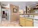 Bright kitchen featuring tile flooring, yellow cabinets, and stainless steel sink and white dishwasher at 3830 E Lakewood Pkwy # 1057, Phoenix, AZ 85048
