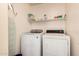 Bright laundry room with newer front-loading washing machine and older dryer at 3830 E Lakewood Pkwy # 1057, Phoenix, AZ 85048