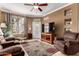 Cozy living room featuring tile floors, a ceiling fan, and large window for ample natural light at 3830 E Lakewood Pkwy # 1057, Phoenix, AZ 85048