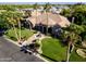 Stunning aerial view of a luxury home with lush landscaping, a circular driveway, mature trees, and a tranquil water fountain at 3949 E Norcroft Cir, Mesa, AZ 85215
