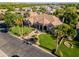 Aerial view of the lushly landscaped desert property featuring mature palms and circular driveway at 3949 E Norcroft Cir, Mesa, AZ 85215