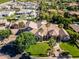 Aerial view of an estate featuring mature landscaping, a circular driveway, and a well-manicured lawn in a lovely neighborhood at 3949 E Norcroft Cir, Mesa, AZ 85215
