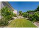 Private backyard showcasing a well-maintained lawn and vibrant citrus trees, creating a serene and inviting outdoor space at 3949 E Norcroft Cir, Mesa, AZ 85215