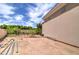 Backyard featuring trees, plants, a block wall, and the side of the house at 3949 E Norcroft Cir, Mesa, AZ 85215