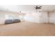 Expansive basement with recessed lighting, carpeting, and two sofas below shuttered windows at 3949 E Norcroft Cir, Mesa, AZ 85215