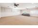 Spacious basement features neutral carpeting, LED lighting, and two windows with white shutters at 3949 E Norcroft Cir, Mesa, AZ 85215