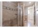 Modern bathroom with tiled shower, glass door, tile accents, and granite counters at 3949 E Norcroft Cir, Mesa, AZ 85215