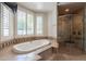 A bathtub with white shutters overlooks a landscaped yard at 3949 E Norcroft Cir, Mesa, AZ 85215