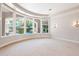 Bright bedroom with carpet floors, transom windows, and views of the backyard pool area at 3949 E Norcroft Cir, Mesa, AZ 85215