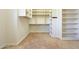 A walk-in closet with built-in shelves and hanging rods at 3949 E Norcroft Cir, Mesa, AZ 85215