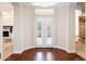 Elegant foyer with hardwood flooring, shuttered windows, and seamless transition to other living spaces at 3949 E Norcroft Cir, Mesa, AZ 85215