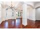 Bright foyer boasts wood floors, arched doorways, designer lighting, and decorative molding at 3949 E Norcroft Cir, Mesa, AZ 85215