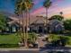 Aerial view of the beautiful single-story stone home with lush landscaping at 3949 E Norcroft Cir, Mesa, AZ 85215