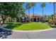 Manicured front lawn and landscaping of this single-story stone home with a fountain at 3949 E Norcroft Cir, Mesa, AZ 85215