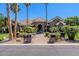 Beautiful single-story stone home with lush landscaping, a fountain, and a brick walkway at 3949 E Norcroft Cir, Mesa, AZ 85215