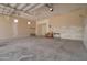Expansive garage interior featuring a cement floor, drywall walls and an overhead garage door at 3949 E Norcroft Cir, Mesa, AZ 85215