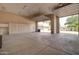 Expansive garage interior featuring built-in cabinetry, an overhead garage door and a cement floor at 3949 E Norcroft Cir, Mesa, AZ 85215