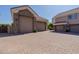 Spacious three-car garage with stone detailing and a large paved driveway, providing plenty of parking space at 3949 E Norcroft Cir, Mesa, AZ 85215