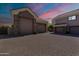 Expansive multi-car garage featuring stone accents and a spacious paved driveway at 3949 E Norcroft Cir, Mesa, AZ 85215