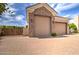 Detached garages feature stone accents and ample parking space with a brick driveway at 3949 E Norcroft Cir, Mesa, AZ 85215