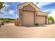 Detached garages feature stone accents and ample parking space with a brick driveway at 3949 E Norcroft Cir, Mesa, AZ 85215