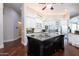 Large kitchen with white cabinets, a center island, and an adjacent pantry at 3949 E Norcroft Cir, Mesa, AZ 85215