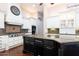 Kitchen island with dark cabinetry and granite countertops, adjacent to stainless steel appliances at 3949 E Norcroft Cir, Mesa, AZ 85215