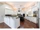 Spacious kitchen features white cabinets, an island and stainless steel appliances at 3949 E Norcroft Cir, Mesa, AZ 85215