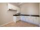 Well-lit laundry room with white cabinets, dark granite countertops, and tile flooring at 3949 E Norcroft Cir, Mesa, AZ 85215