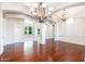 Open-concept living area with wood floors, decorative columns, and views of the pool at 3949 E Norcroft Cir, Mesa, AZ 85215
