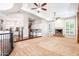 Open living room features a fireplace, neutral carpet, and adjoins a kitchen with white cabinets at 3949 E Norcroft Cir, Mesa, AZ 85215