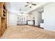 Spacious living room with neutral carpet, ceiling fans, and access to the kitchen at 3949 E Norcroft Cir, Mesa, AZ 85215