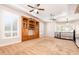 Expansive living area with a built-in wooden cabinet and multiple ceiling fans at 3949 E Norcroft Cir, Mesa, AZ 85215