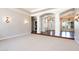 Spacious living room with hardwood floors and decorative columns, offering a grand and open atmosphere at 3949 E Norcroft Cir, Mesa, AZ 85215