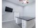 Modern office space equipped with a built-in desk, ample storage, and a sleek, mounted television at 3949 E Norcroft Cir, Mesa, AZ 85215