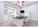 Bright office with custom built-ins, granite countertop desk, ceiling fan, and pool view window at 3949 E Norcroft Cir, Mesa, AZ 85215