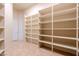 Walk-in pantry with multiple shelves, providing ample storage for kitchen supplies and food items at 3949 E Norcroft Cir, Mesa, AZ 85215