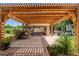 Covered outdoor patio with a pergola and lush landscaping at 3949 E Norcroft Cir, Mesa, AZ 85215
