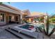 Backyard oasis with pool, spa, patio seating, and lush tropical landscaping at 3949 E Norcroft Cir, Mesa, AZ 85215