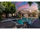 Backyard pool area with diving board and lush landscaping creating a private oasis at 3949 E Norcroft Cir, Mesa, AZ 85215