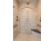 A frameless shower with multiple showerheads and a built-in bench at 3949 E Norcroft Cir, Mesa, AZ 85215