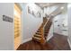 Elegant staircase with carpeted steps, decorative iron railing, and view of walk-in pantry at 3949 E Norcroft Cir, Mesa, AZ 85215