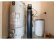 Utilities room with water heater and water filtration system at 3949 E Norcroft Cir, Mesa, AZ 85215