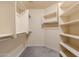 Spacious walk-in closet with custom shelving and hanging rods for optimal organization and storage at 3949 E Norcroft Cir, Mesa, AZ 85215