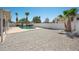 Backyard with sparkling pool, palm trees, and desert landscaping, perfect for relaxation and outdoor enjoyment at 4319 E Tanglewood Dr, Phoenix, AZ 85048