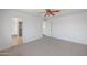 Bedroom featuring carpet flooring, open closet, and an ensuite bathroom at 4319 E Tanglewood Dr, Phoenix, AZ 85048