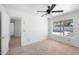 Bright bedroom with neutral carpet, ceiling fan, and view of the back patio at 4319 E Tanglewood Dr, Phoenix, AZ 85048