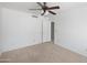 Spacious bedroom featuring neutral carpet, white walls, and ceiling fan at 4319 E Tanglewood Dr, Phoenix, AZ 85048